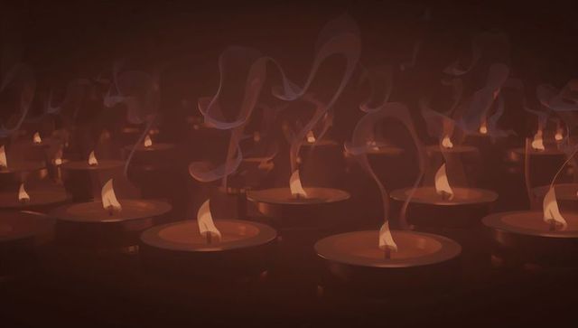 Dimly lit shrine with glowing metal oil lamps and flickering flames