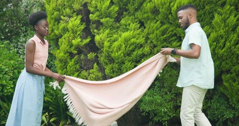 Couple Enjoying Outdoor Leisure Near Lush Greenery