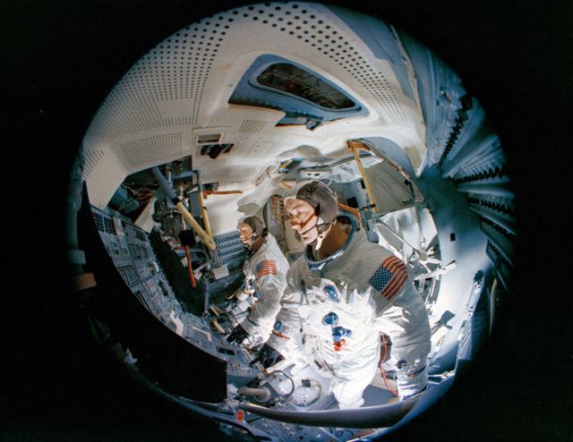 S69-19981 (23 Feb. 1969) --- Fish-eye camera lens view of the interior of the Apollo Lunar Module Mission Simulator (LMMS) at the Kennedy Space Center (KSC) during Apollo 9 simulation training. In the foreground is astronaut James A. McDivitt, prime crew commander; and in background is astronaut Russell L. Schweickart, lunar module pilot.