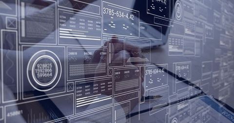 Typing on laptop analyzing dashboard data with transparent digital analytics overlays