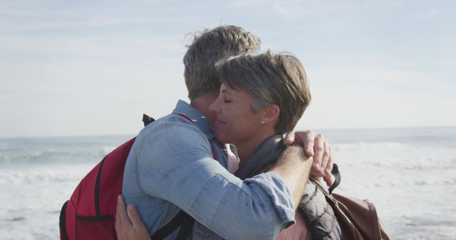 Middle-aged couple embracing near ocean on peaceful sunny day - Download Free Stock Images Pikwizard.com