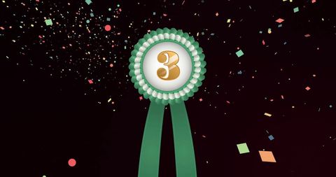 Green Ribbon Medal with Gold Number and Confetti for Celebratory Event