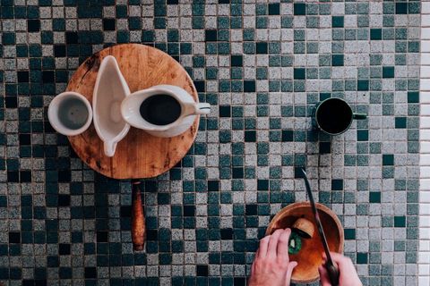 Overhead view of minimalist kitchen tile and crockery