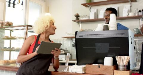 Diverse Team Collaborating in Coffee Shop Environment