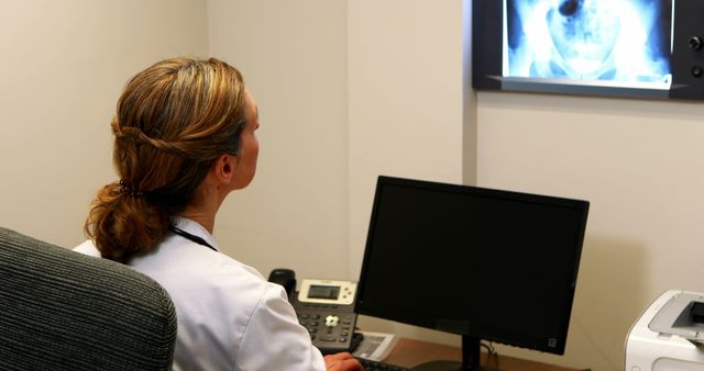 Female Radiologist Examining X-Ray in Medical Office - Download Free Stock Images Pikwizard.com