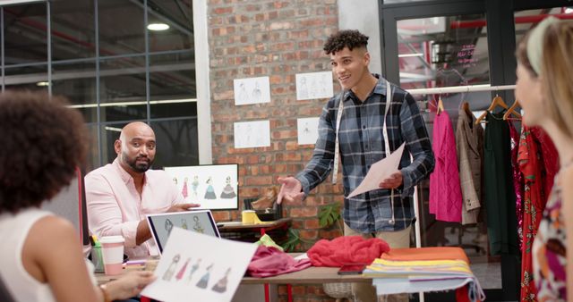 Young Designer Presenting Fashion Designs to Mixed Ethnicity Team in Modern Office - Download Free Stock Images Pikwizard.com