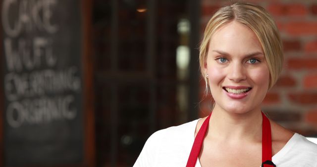 Smiling Female Bakery Worker Wearing Red Apron in Organic Cafe - Download Free Stock Images Pikwizard.com