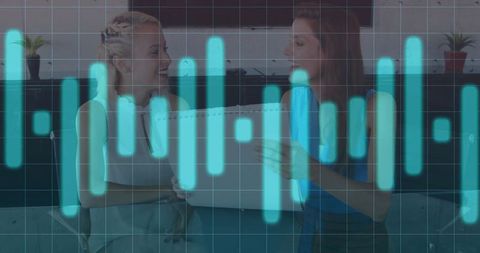 Two Women Collaborating with Business Graph Overlay Technology