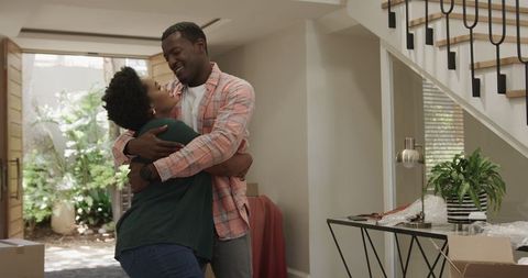 Joyful couple bonding in modern living room