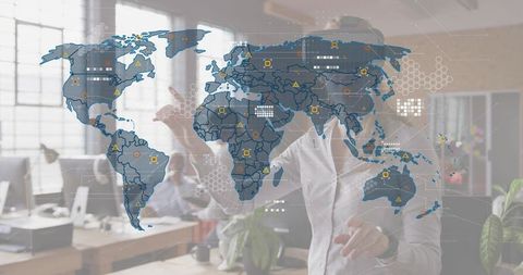 Businessman interacting with holographic world map in modern office for global teamwork