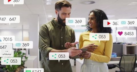 Coworkers Analyzing Digital Metrics in a Modern Office Environment