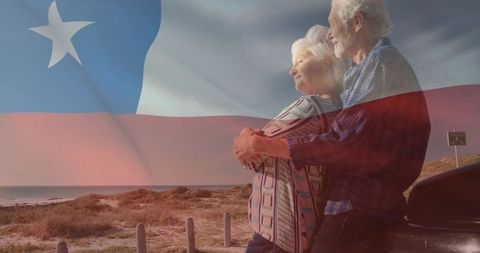 Senior couple embracing on coastal road with chilean flag overlay, retirement romance
