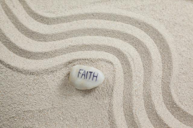 White Pebble with 'Faith' on Sand with Wavy Patterns - Download Free Stock Photos Pikwizard.com