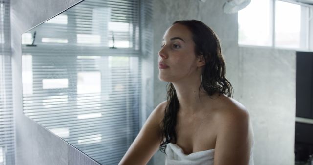 Woman Wrapped in Towel Looking at Herself in Bathroom Mirror - Download Free Stock Images Pikwizard.com