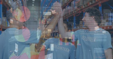 Volunteers Celebrating in Warehouse with Data Graphics Overlay - Download Free Stock Images Pikwizard.com