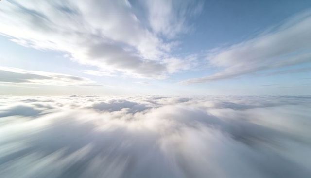 Gliding Cloudscape with Motion Blur, Sunlit Horizon, Airy Layers, Dreamy Blue Sky Panorama