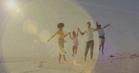 Joyful Family Playing on Sunny Beach with Lens Flare