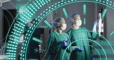 Female Surgeons Analyzing Medical Data with Technology in Operating Room - Download Free Stock Images Pikwizard.com