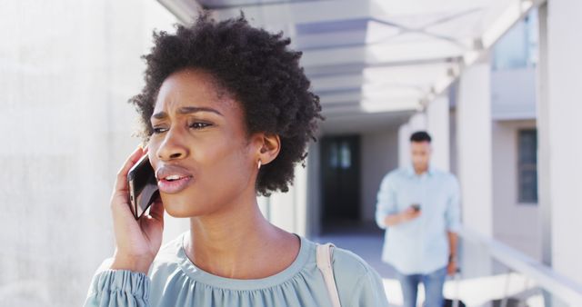 Worried African American Woman Talking on Smartphone Outside Office Building - Download Free Stock Images Pikwizard.com