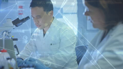 Asian Scientist Using Microscope with Digital Overlay in Lab