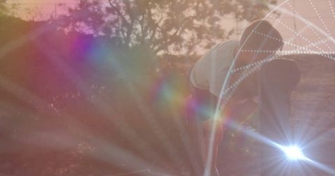 Energetic Boy Climbing in Vibrant Sunset with Lens Flare