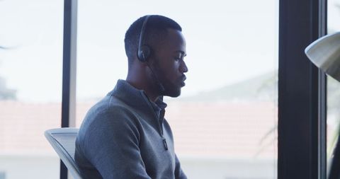 Focused Businessman Wearing Headset During Work in Modern Office
