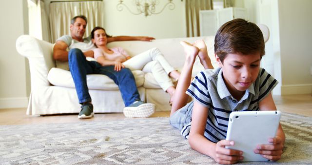 Family Relaxing in Living Room While Child Plays with Tablet - Download Free Stock Images Pikwizard.com