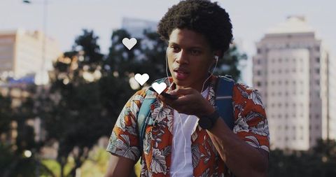 Young Man Speaking on Smartphone Outdoor with Heart Icons