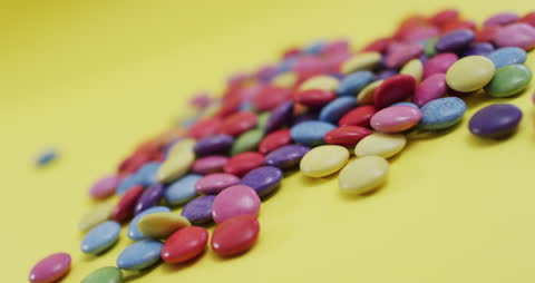 Vibrant Assortment of Candy on Yellow Background