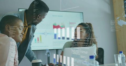 Team Analyzing Data Insights with Interactive Technology in Conference Room