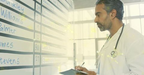 Doctor analyzing daily schedule in hospital with clipboard