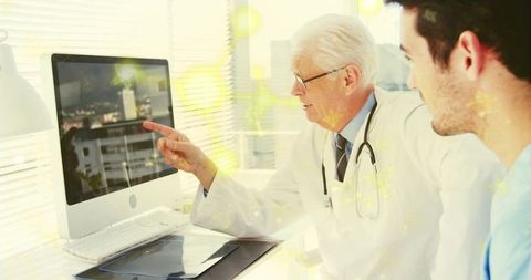 Doctor explaining test results on computer in clinical setting