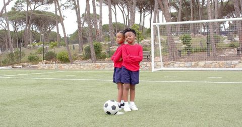 Child Teammates Ready for Game on Soccer Field