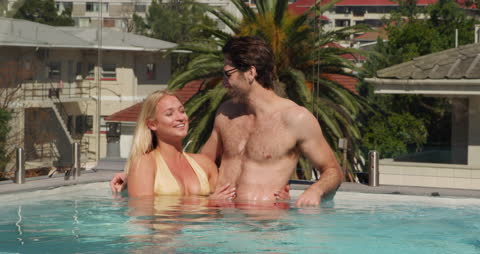 Couple Relaxing in Private Pool on Sunny Summer Day
