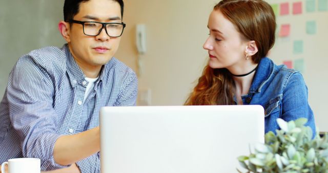 Two Colleagues Collaborating on Laptop in Modern Office Environment - Download Free Stock Images Pikwizard.com