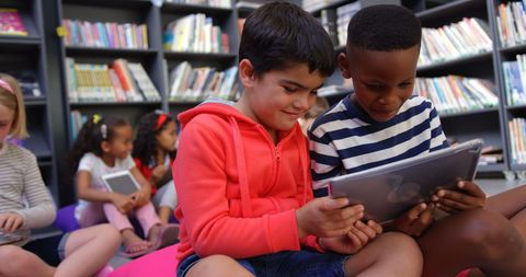Happy Students Collaborating on Tablet in Library Setting - Download Free Stock Images Pikwizard.com