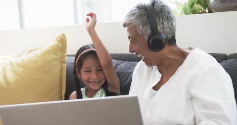 Grandmother and Granddaughter Sharing Headphones Enjoying Music - Download Free Stock Images Pikwizard.com