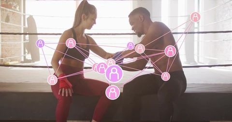 Trainer wrapping fighter's hands on ring apron with pink social network overlay