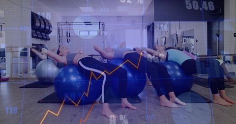 Group Pilates backbend class using stability balls in modern studio with data overlay