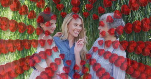 Three Generation Women Bonding Amidst Digital Hearts in Garden