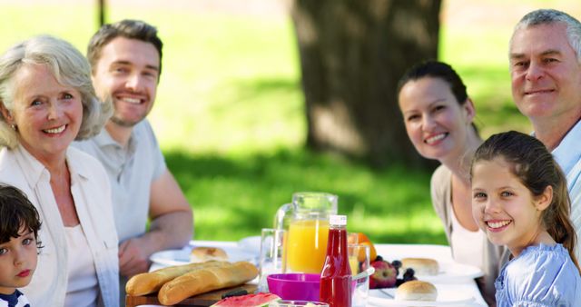 Smiling Multigenerational Family Enjoying Outdoor Picnic - Download Free Stock Images Pikwizard.com