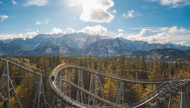 Roller coaster adventure in mountainous forest landscape