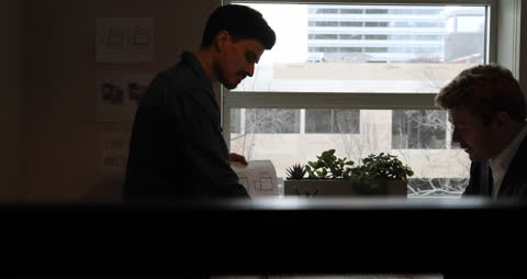 Architects Reviewing Plans in Modern Office Setting
