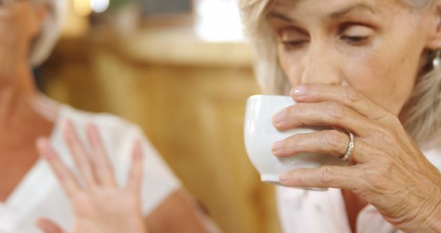 Senior Woman Enjoying Drink While Gesturing in Coffee Shop - Download Free Stock Images Pikwizard.com