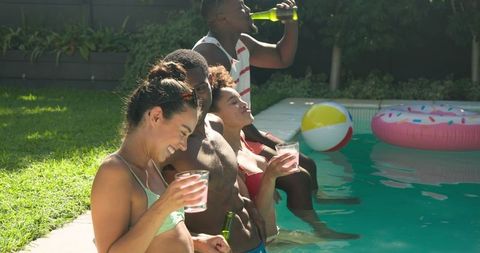 Diverse Friends Enjoying Poolside Together with Refreshments