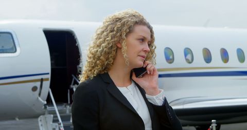 Businesswoman Communicating at Private Jet Terminal - Download Free Stock Images Pikwizard.com