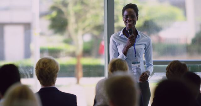 Confident Woman Giving Presentation to Diverse Audience - Download Free Stock Images Pikwizard.com