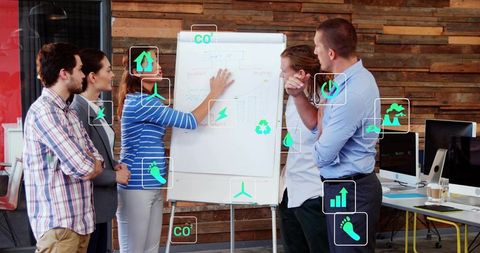 Team presenting sustainable strategy on flipchart in modern office with eco icons