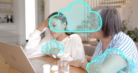 Teen receiving comfort from mother while using laptop with teal digital cloud overlay