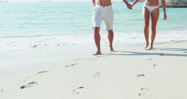 Couple Walking on Sandy Beach Holding Hands in Summer - Download Free Stock Images Pikwizard.com